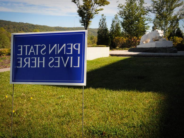 sign reading "penn state lives here" in the ground in front of the penn state lehigh valley nittany lion shrine